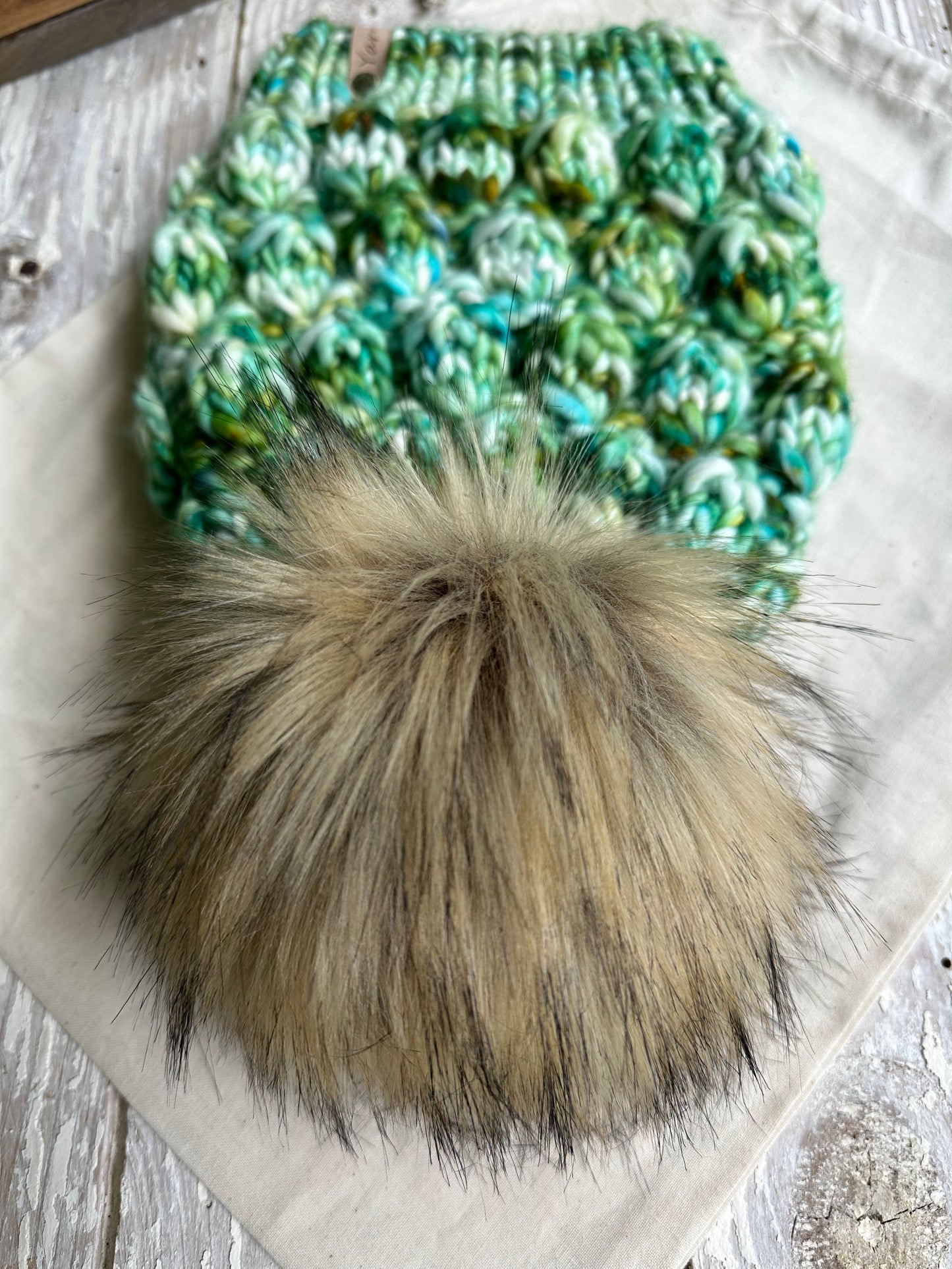 Slouchy merino wool knit hat with faux fur pom