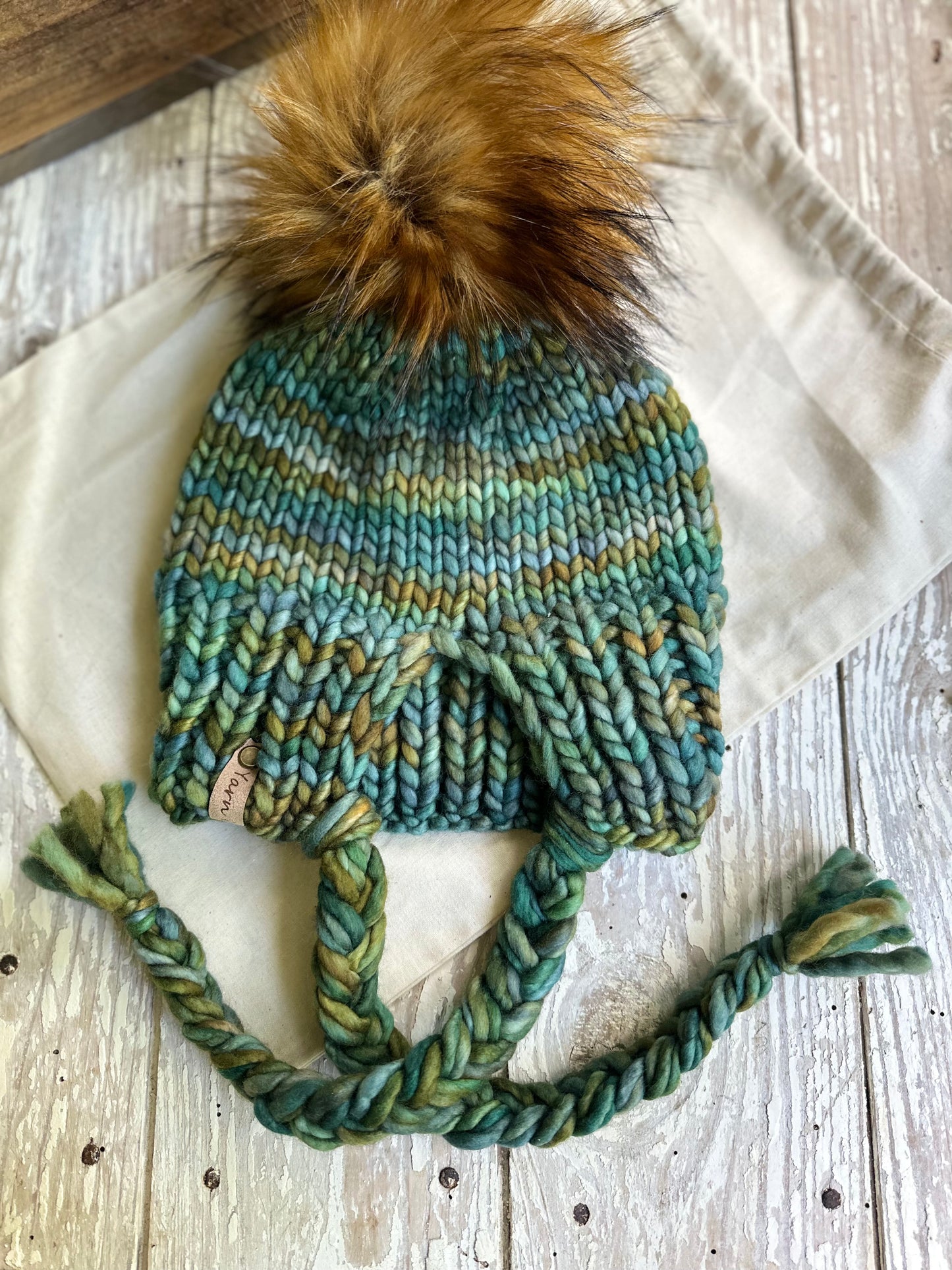 Merino wool split brim beanie with faux fur Pom