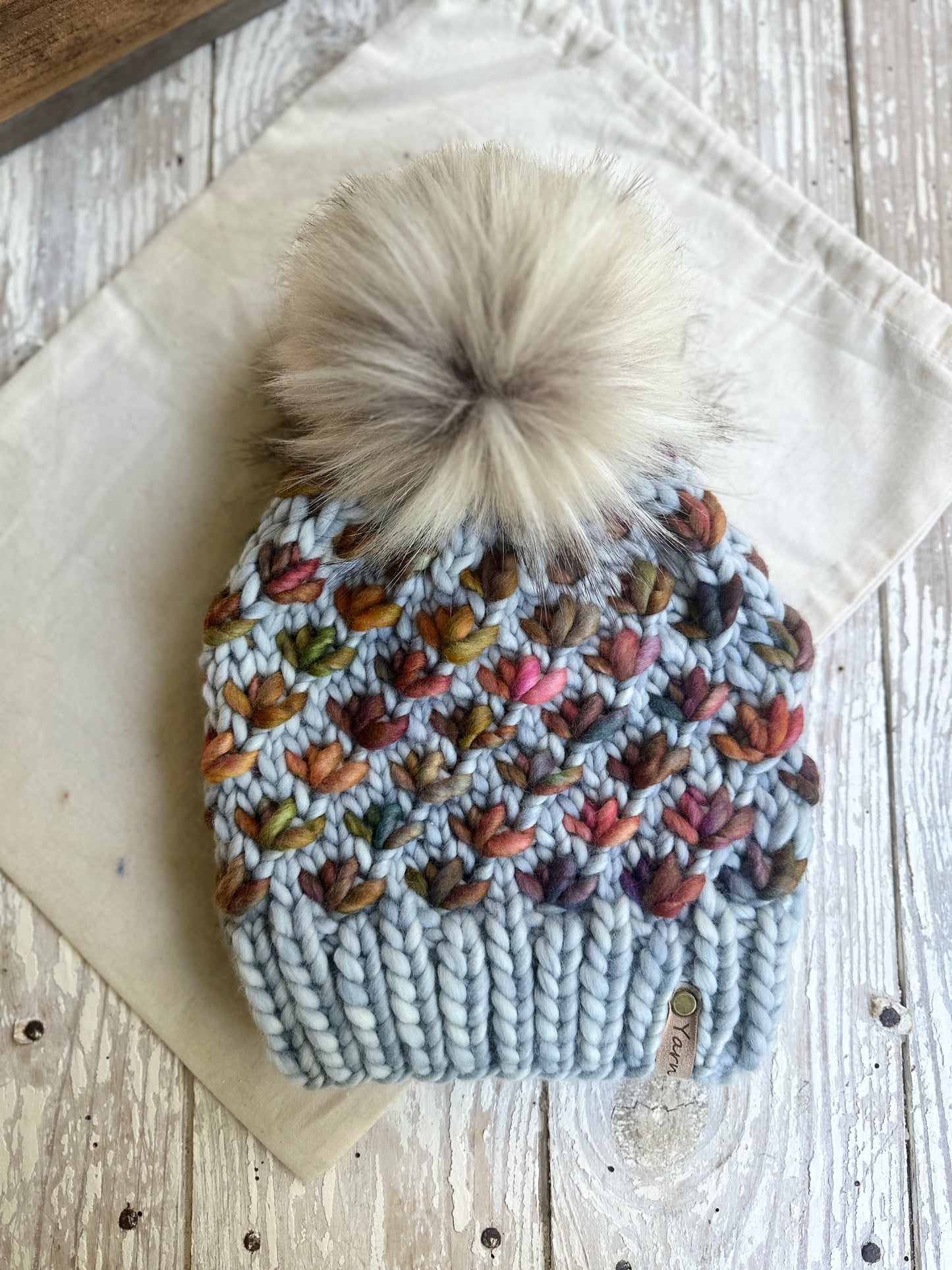 Merino wool knit hat with faux fur pom