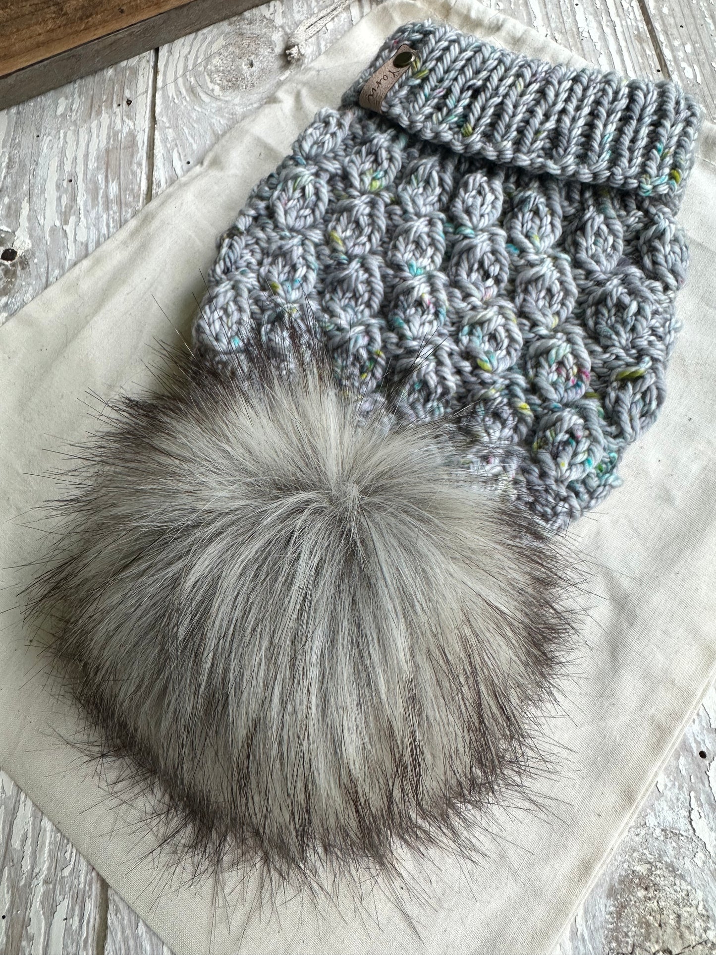 Merino wool knit folded brim beanie with faux fur pom