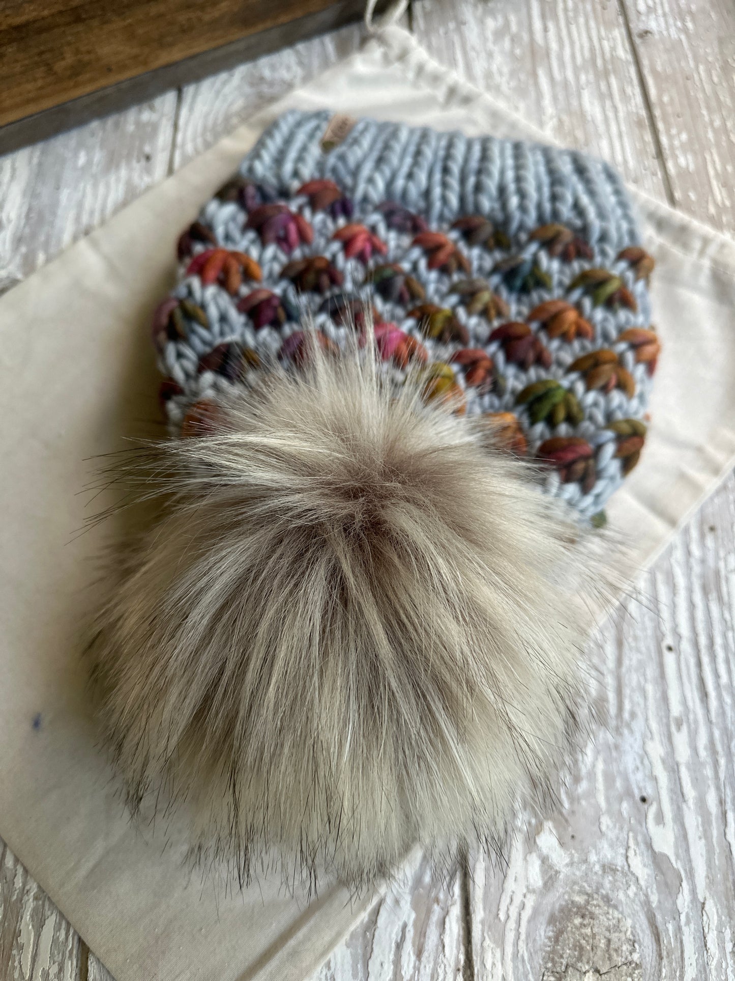 Merino wool knit hat with faux fur pom