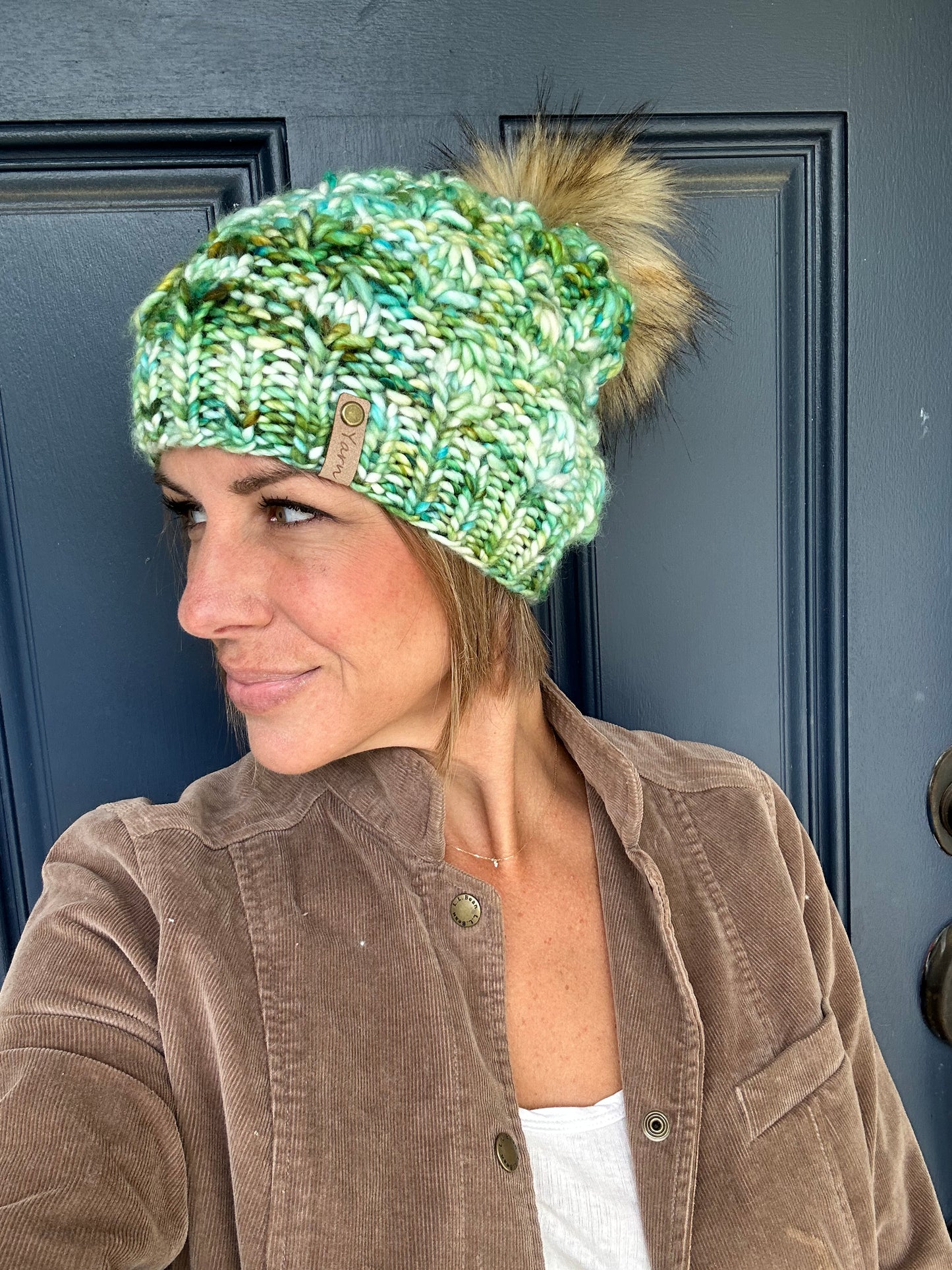 Slouchy merino wool knit hat with faux fur pom